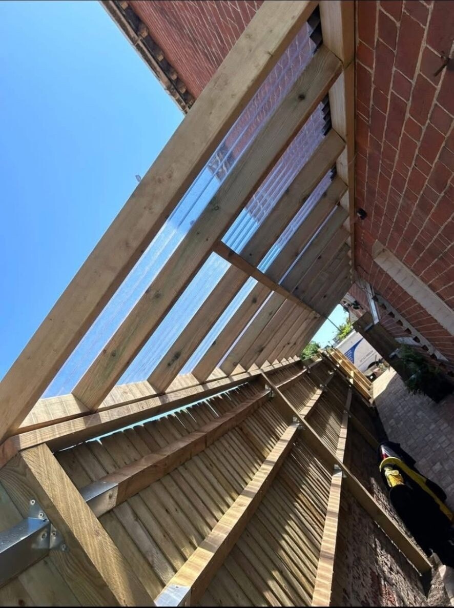 New timber pergola structure built into a Sussex back garden during construction.