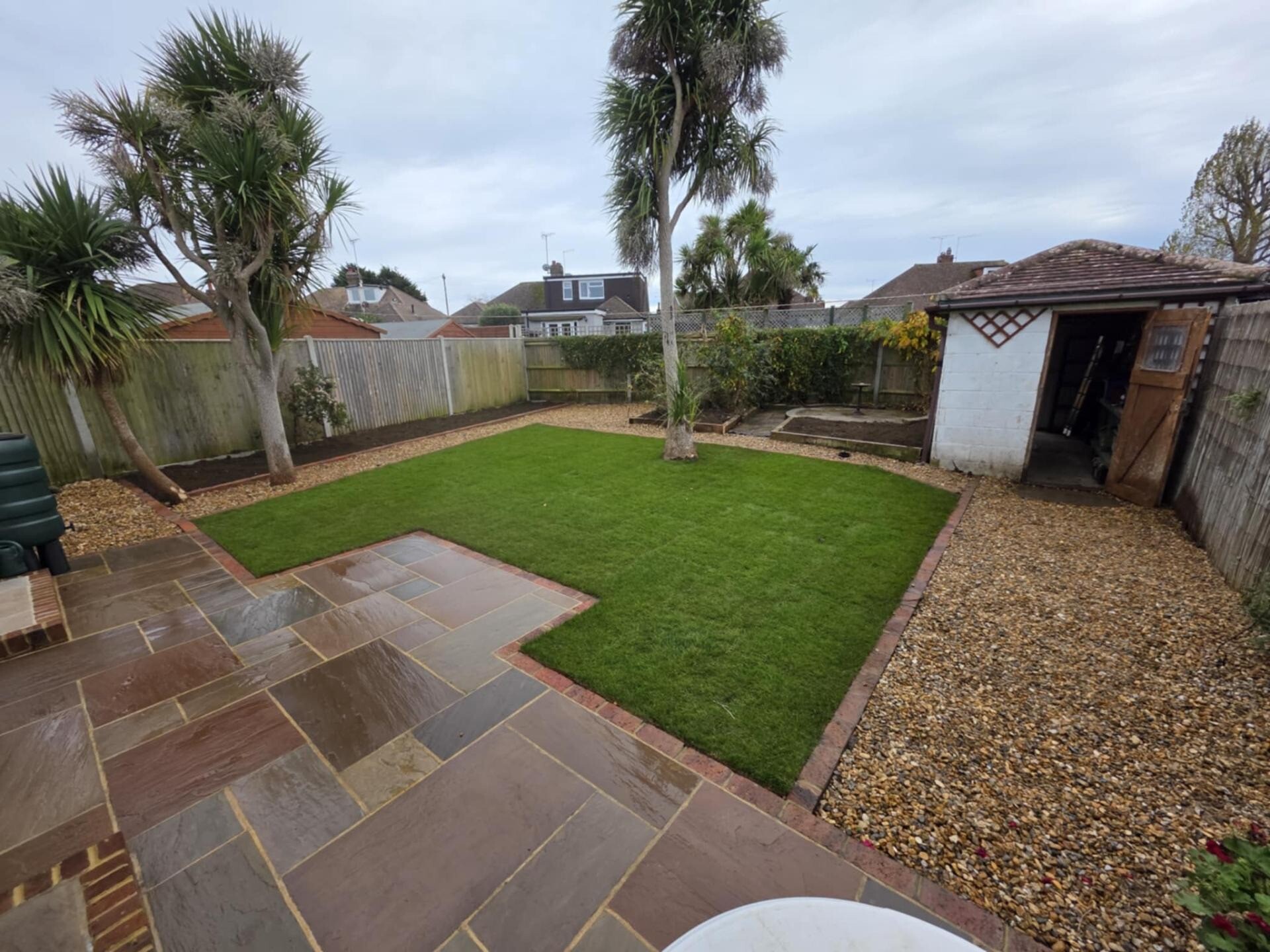Full garden transformation featuring patio, gravel and planted borders.
