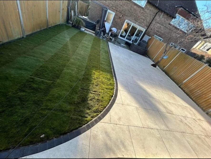 Artificial grass lawn with a hard-paved path running alongside.