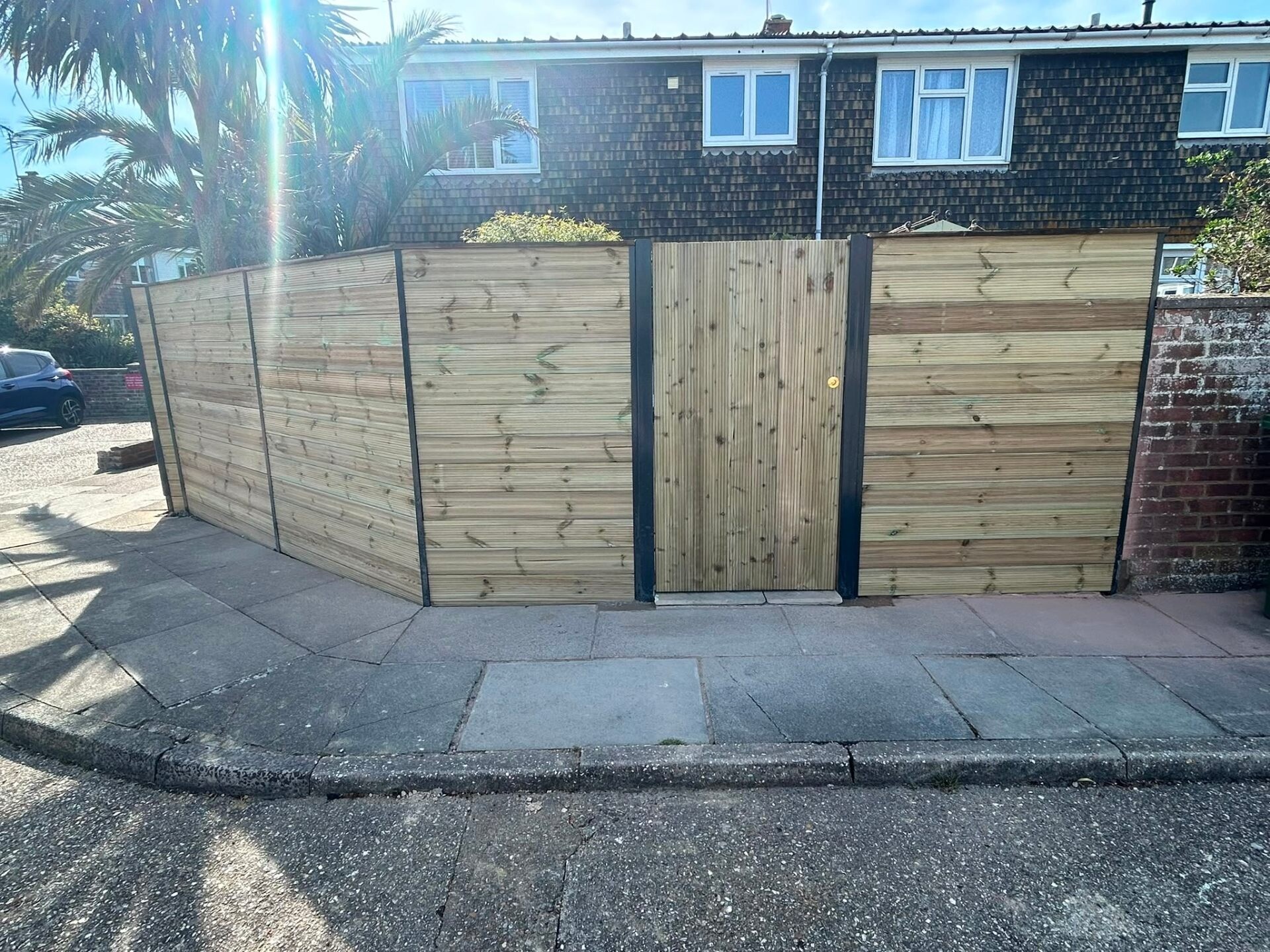 New closeboard fencing run installed alongside a paved driveway in Sussex.